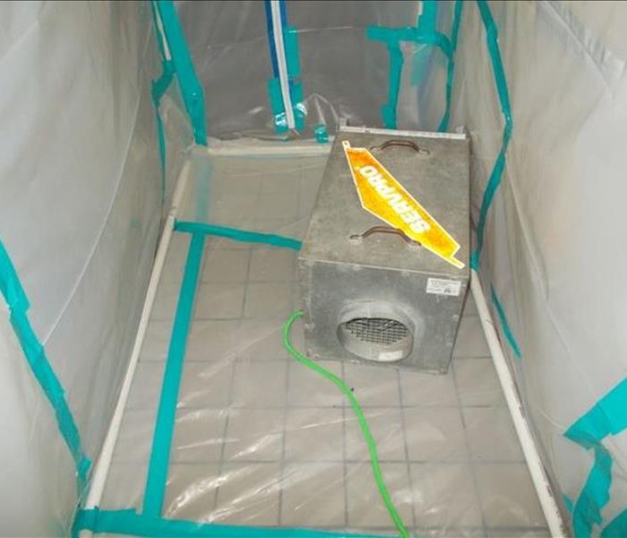 Picture of a piece of equipment in a chamber created out of plastic material