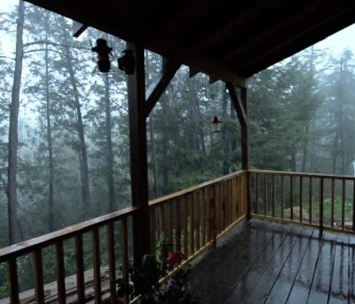 View from the shelter of a porch, of heavy showers raging on.